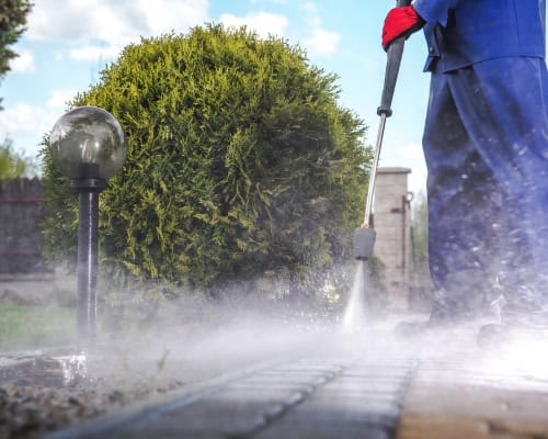 Pressure washing brick patio